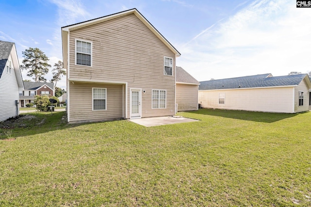 rear view of property featuring a patio and a lawn