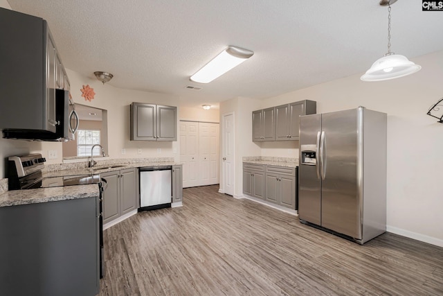 kitchen featuring light wood-type flooring, visible vents, appliances with stainless steel finishes, and gray cabinetry