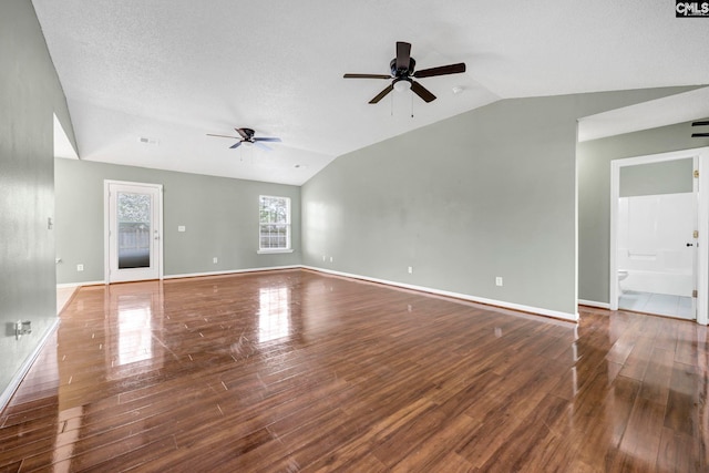 unfurnished living room featuring lofted ceiling, ceiling fan, baseboards, and wood finished floors