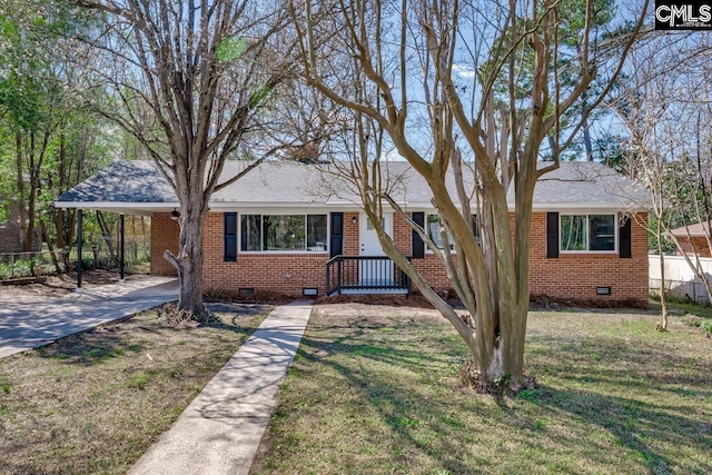 ranch-style house with an attached carport, crawl space, brick siding, and a front lawn