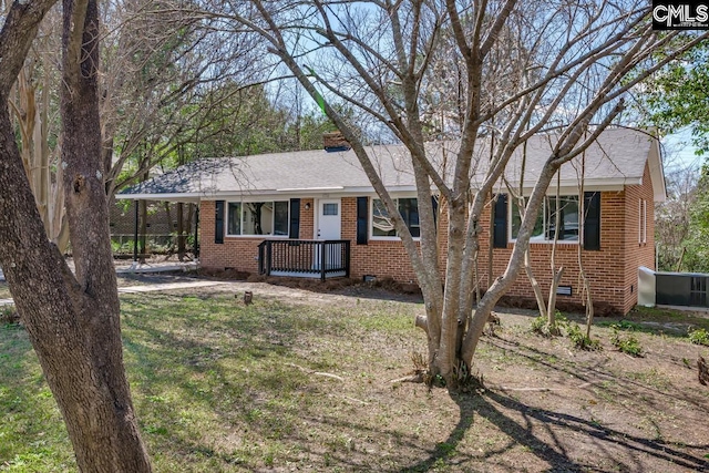 ranch-style home featuring a porch, crawl space, and brick siding