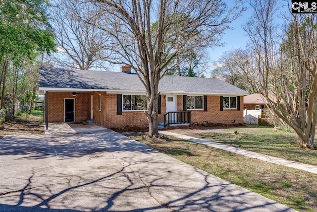 ranch-style home with driveway, a chimney, crawl space, fence, and brick siding