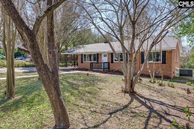 ranch-style house featuring crawl space, covered porch, a front yard, and brick siding