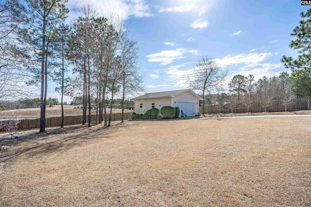 view of yard with fence and an outbuilding