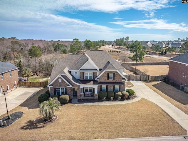 view of front facade featuring a gate, fence, a front lawn, and concrete driveway