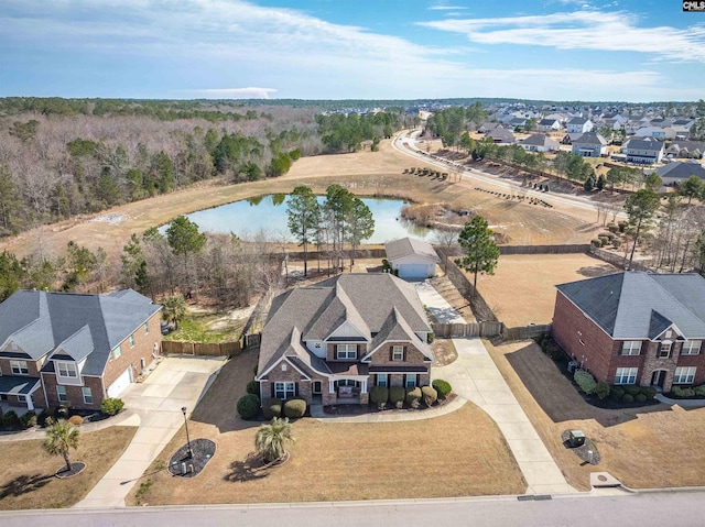 bird's eye view with a water view and a residential view