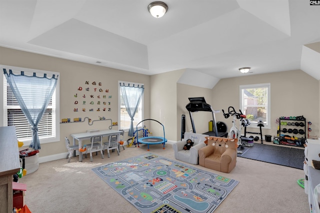 game room with lofted ceiling, carpet floors, and a raised ceiling