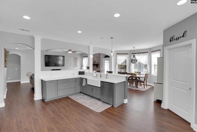 kitchen featuring arched walkways, visible vents, gray cabinetry, a sink, and dishwasher