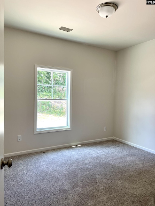 unfurnished room with carpet floors and baseboards