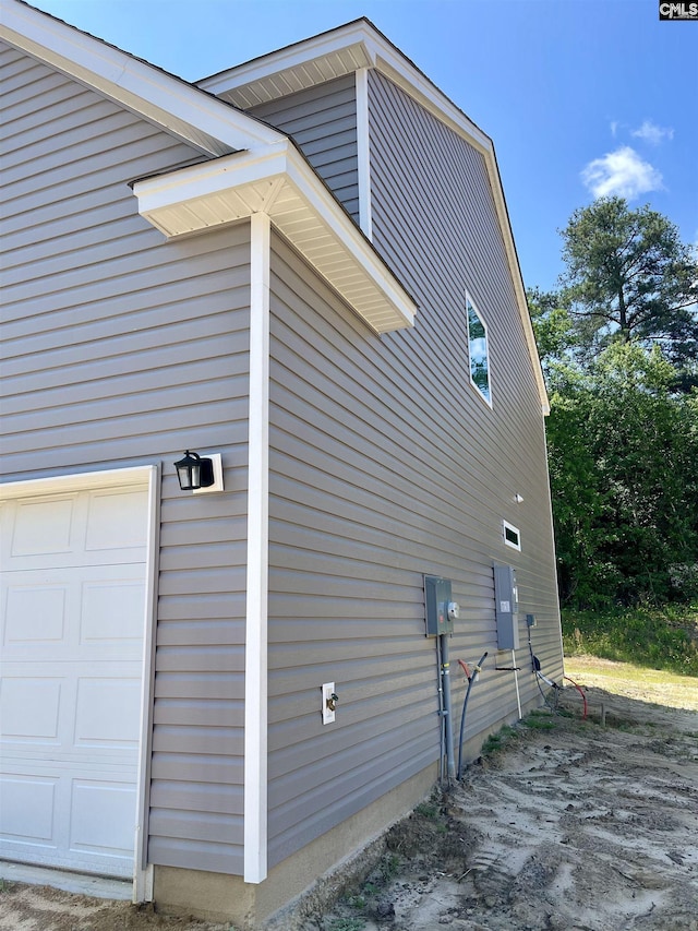 view of side of home with a garage