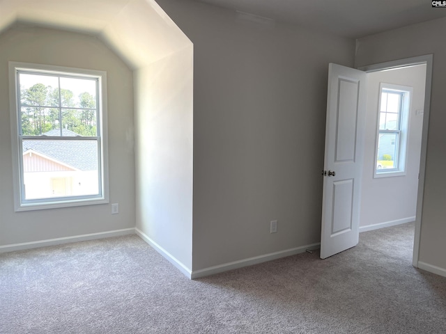 empty room with plenty of natural light, carpet flooring, and baseboards