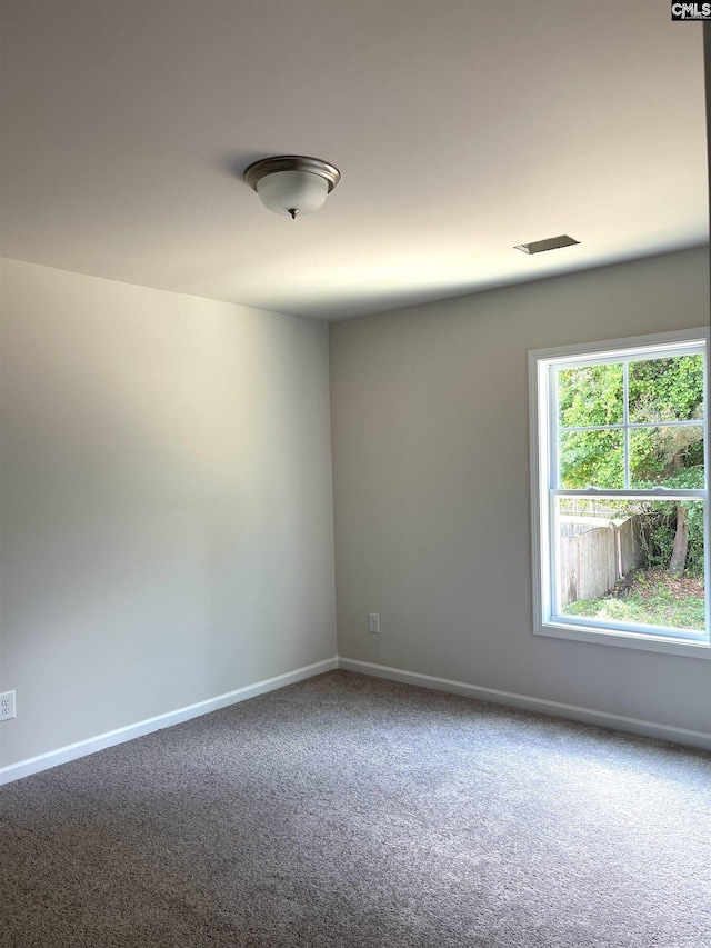 carpeted spare room with baseboards