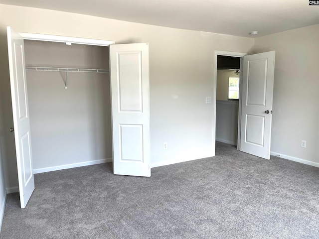 unfurnished bedroom with carpet, baseboards, and a closet