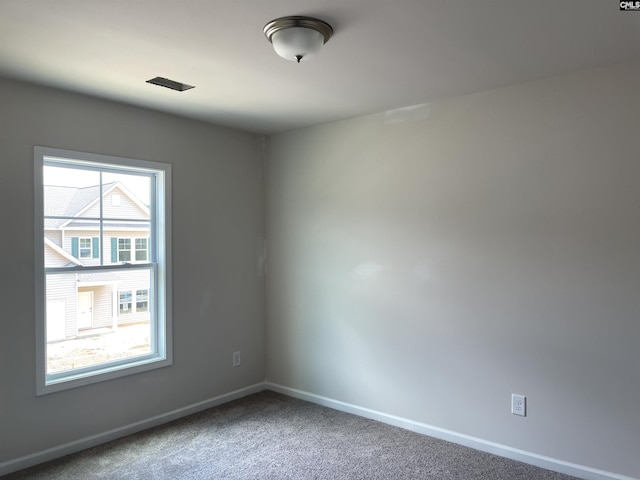 spare room with carpet flooring and baseboards