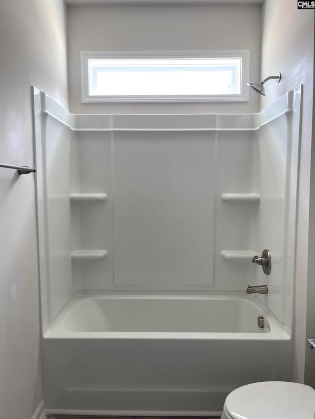 bathroom with toilet, plenty of natural light, and shower / bathtub combination