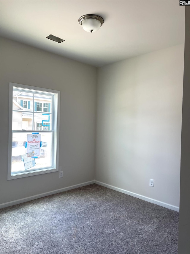 carpeted empty room with baseboards