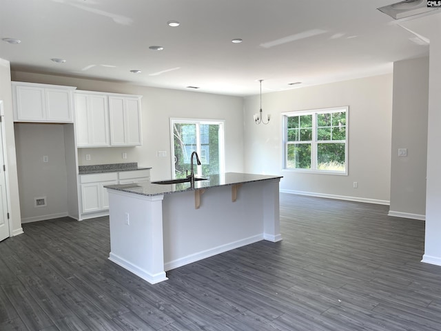 kitchen featuring dark wood finished floors, a sink, a wealth of natural light, and white cabinetry