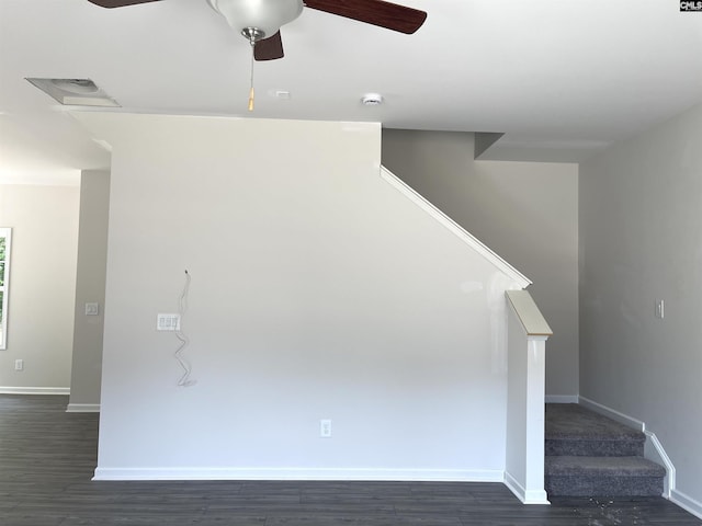 interior space with stairs, baseboards, dark wood-type flooring, and a ceiling fan