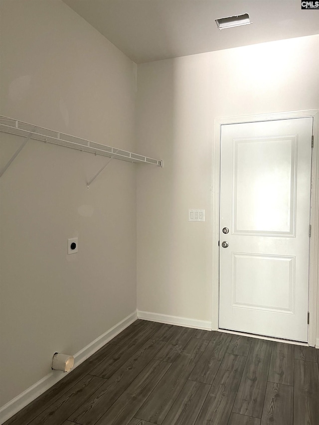 laundry room with dark wood-style floors, laundry area, electric dryer hookup, and baseboards