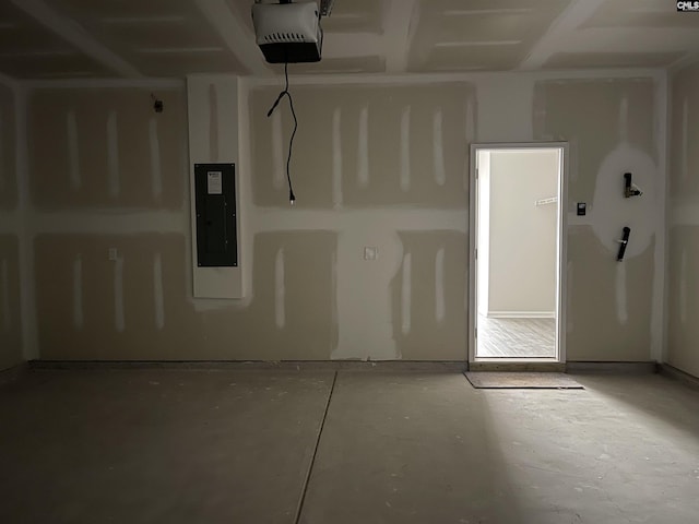 garage featuring electric panel and a garage door opener