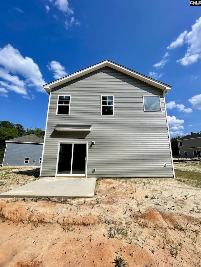 back of property with a patio