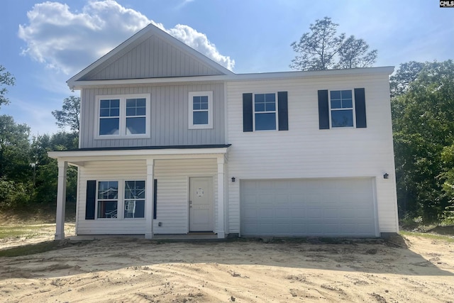 view of front of house with an attached garage, driveway, and board and batten siding