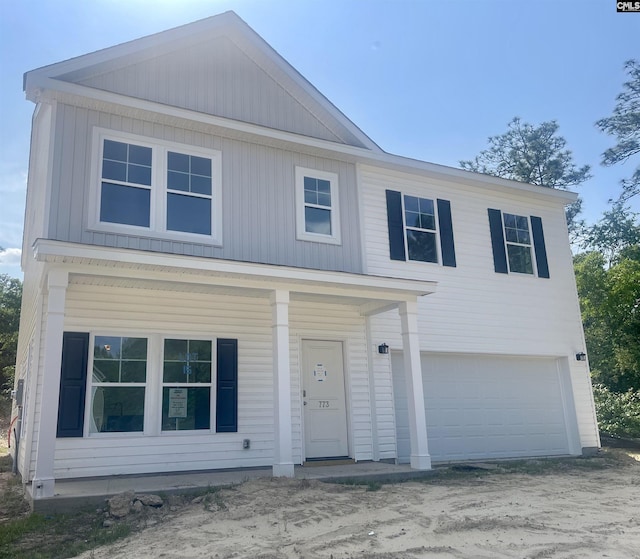 view of front of home with a garage and a porch