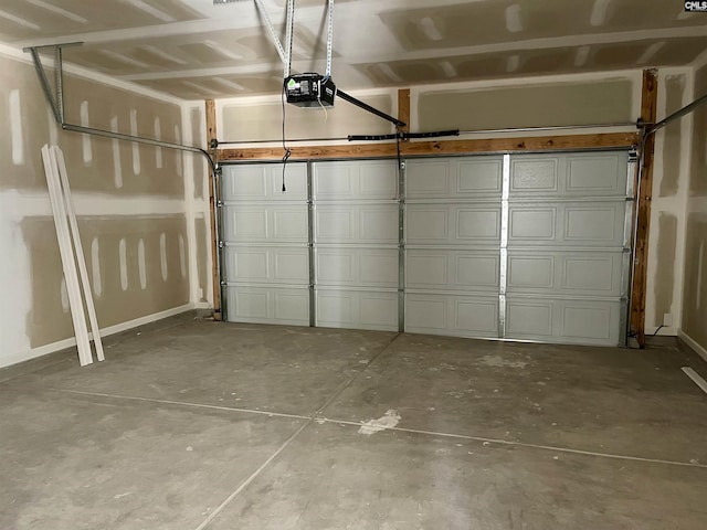 garage with baseboards and a garage door opener