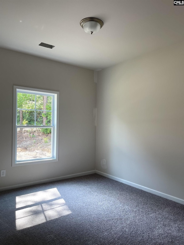 unfurnished room featuring carpet flooring and baseboards