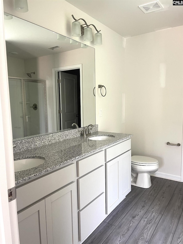 full bathroom with a stall shower, visible vents, and a sink