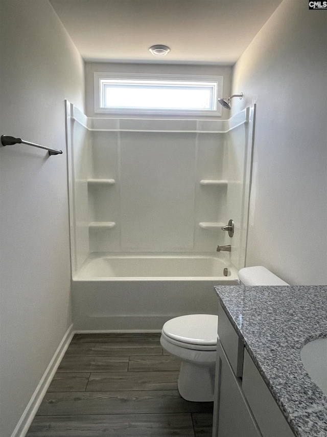 bathroom with shower / bathing tub combination, plenty of natural light, vanity, and toilet