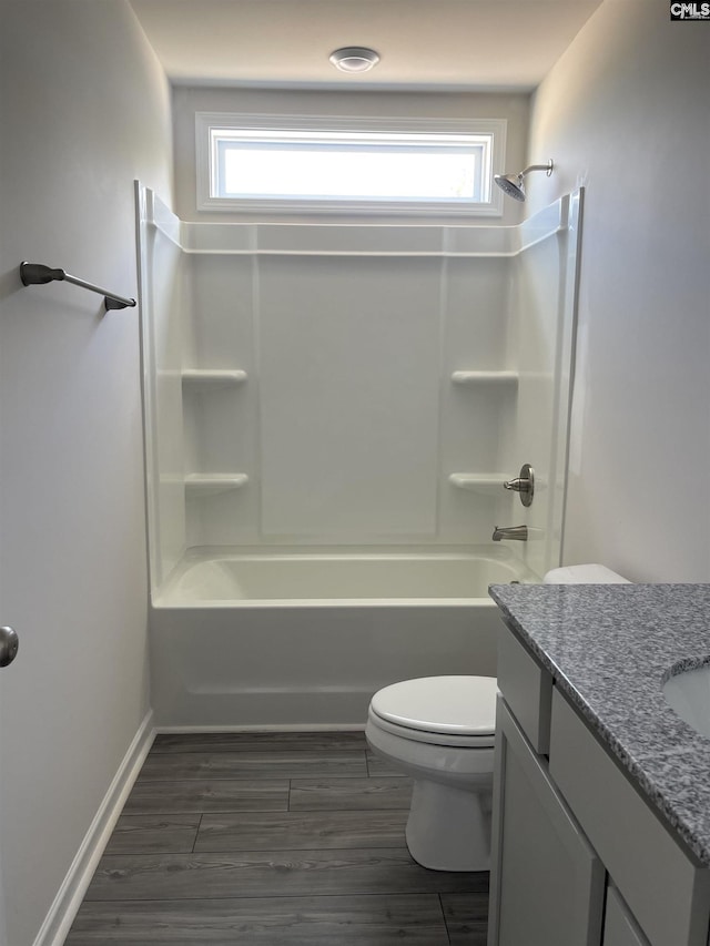 full bath with wood finished floors, shower / tub combination, toilet, and a healthy amount of sunlight