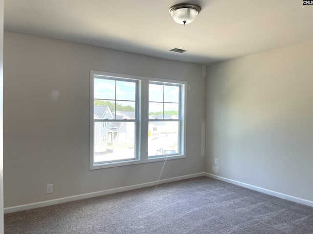 carpeted empty room with baseboards