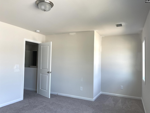 unfurnished bedroom with carpet flooring and baseboards