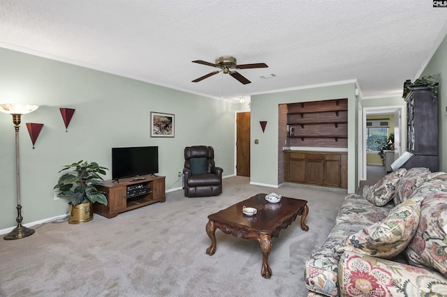 carpeted living area with ornamental molding, visible vents, a textured ceiling, and baseboards