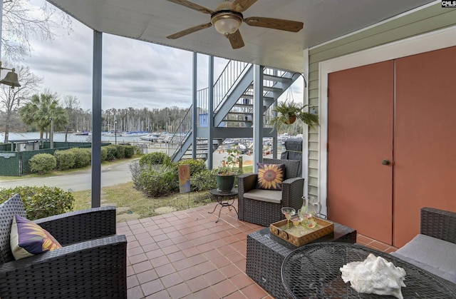 sunroom featuring a ceiling fan