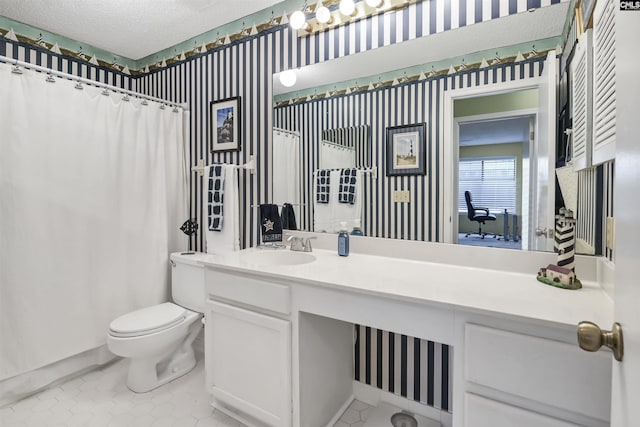 bathroom with wallpapered walls, a shower with shower curtain, toilet, a textured ceiling, and vanity