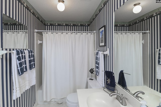 bathroom with toilet, shower / bath combo, a textured ceiling, and vanity