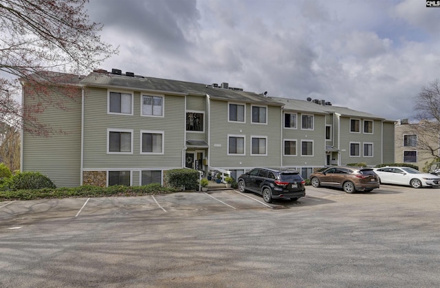 view of building exterior featuring uncovered parking