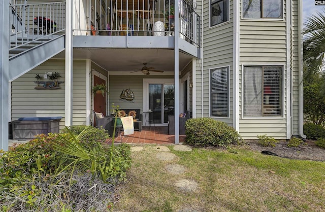 back of property with a ceiling fan, a patio, and a balcony