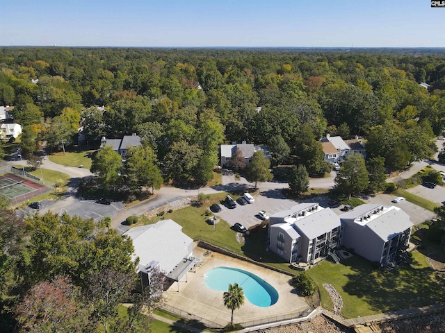 bird's eye view with a wooded view