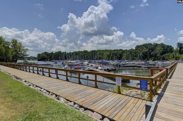 dock area featuring a forest view and a water view