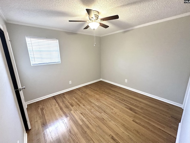 spare room with baseboards, ceiling fan, ornamental molding, and wood finished floors