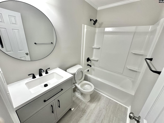 full bathroom featuring toilet, ornamental molding, wood finished floors,  shower combination, and vanity