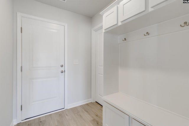 mudroom with light wood-style floors and baseboards