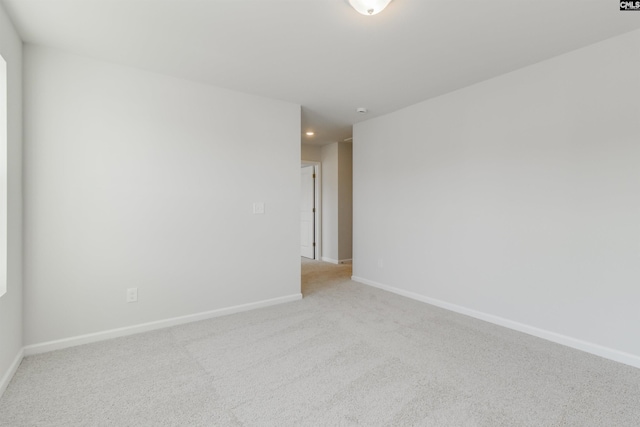 empty room featuring baseboards and carpet flooring