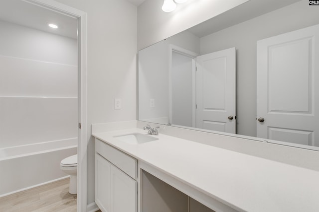 full bath with vanity, toilet, and wood finished floors