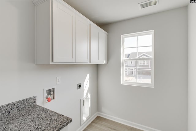 laundry area featuring light wood-style flooring, visible vents, baseboards, cabinet space, and electric dryer hookup