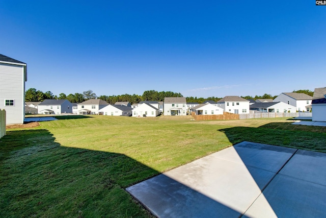 view of yard with a patio area, a residential view, and fence