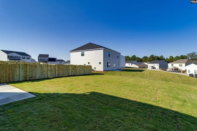 view of yard with fence and a residential view